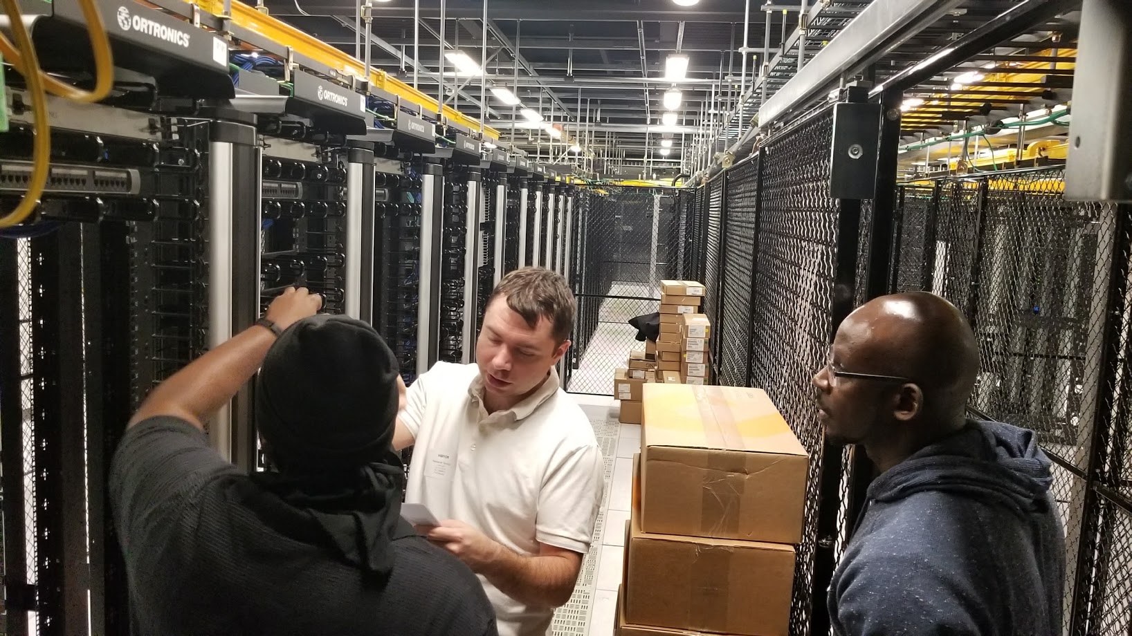 Technical team working among data center racks